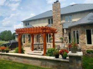 A third view of the Outdoor Living Space, with pergola, fire pit, kitchen, patio, furniture, and more