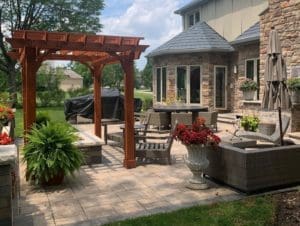 Another view of an Outdoor Living Space with Pergola, Patio, Kitchen, Furniture, and more