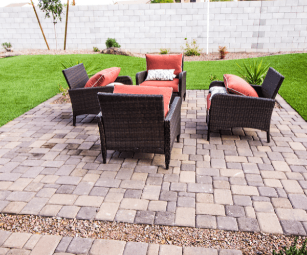 Paver brick and stone patio in a backyard