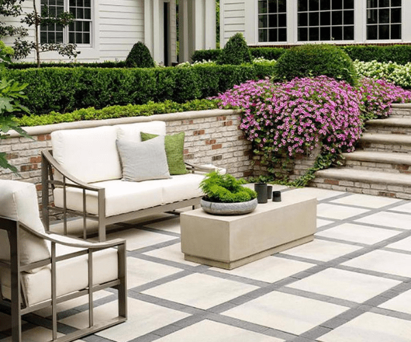 Large stone patio with furniture sitting on top to create a nice outdoor living area