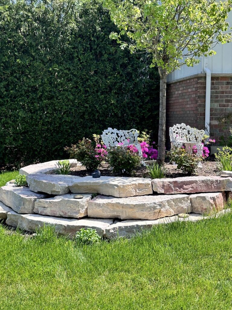 Outcropping stone retaining wall for a garden