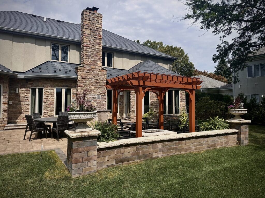 Outdoor Living Space with pergola fire pit seat wall pillars and dining area