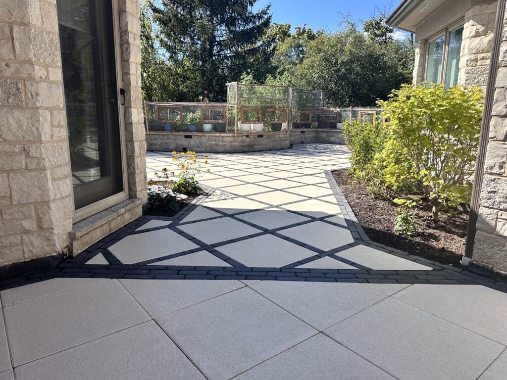 Unilock Arcana paver patio designed in a grid patio in black and white paver colors