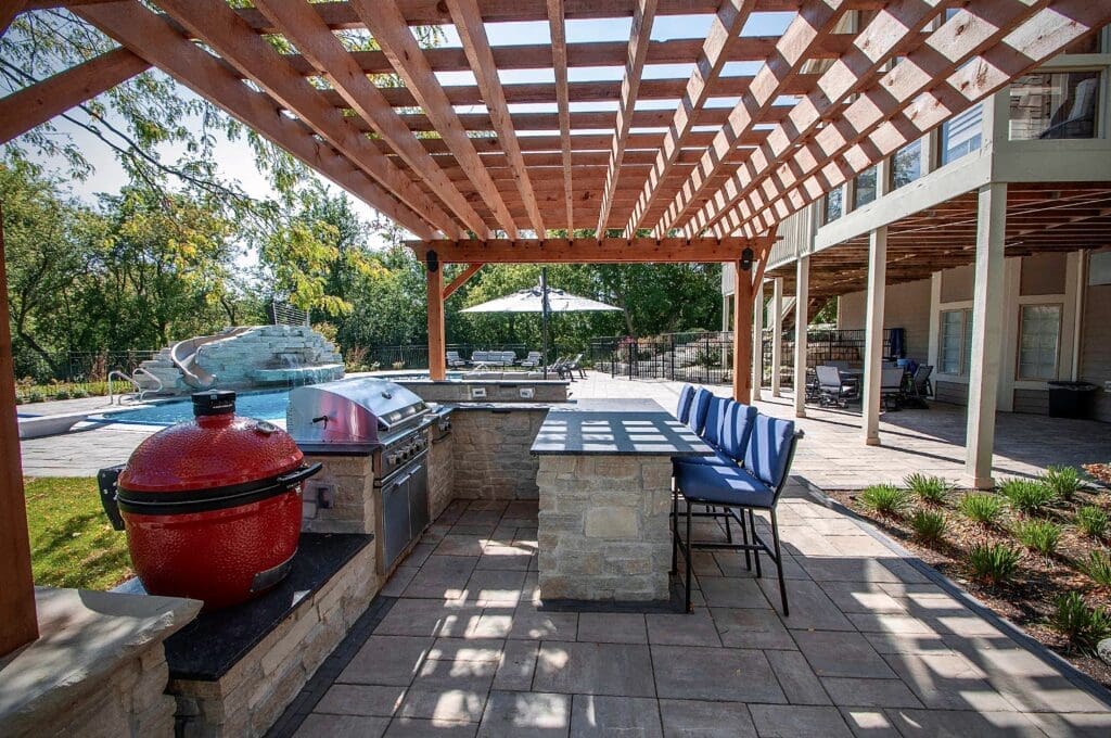 Classic Outdoor Kitchen with Bar Seating Smoker Egg and Pergola