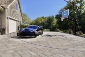 Luxury paver driveway with integrated basketball court using Unilock Beacon Hill Smooth and precision-cut court lines
